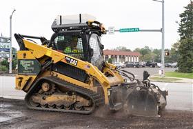 Blooming Glen Contractors: A Caterpillar 289D, equipped with a cold planer attachment, mills asphalt before new base and top are paved.