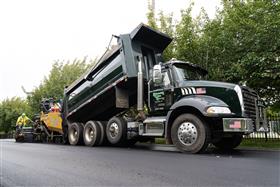 Blooming Glen Contractors: A BGC Mack Granite dumps a load of blacktop into the hopper of a Caterpillar AP655F paver. 